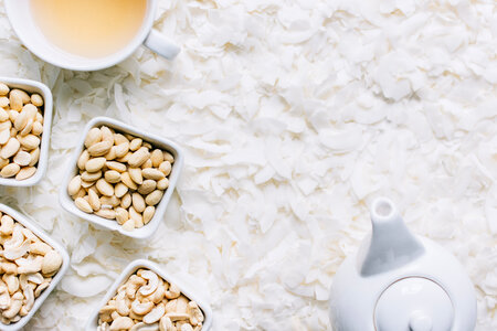 Nuts with tea on coconut flakes photo