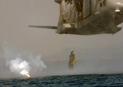 Military Helicopter rescue helicopter during a water landing photo