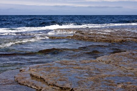 rock and splashing waves in sea photo
