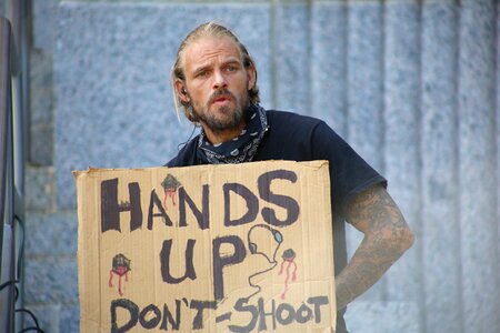 Scruffy hands up sign