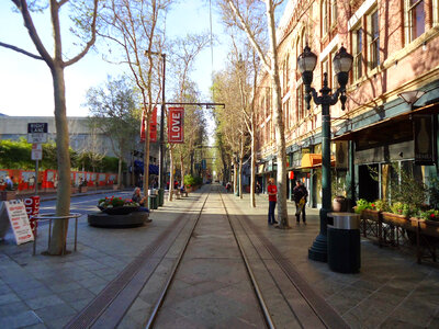 Downtown San Jose sidewalk in San Jose, California with trees and buildings photo