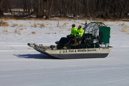 Employee operates a Service airboat photo