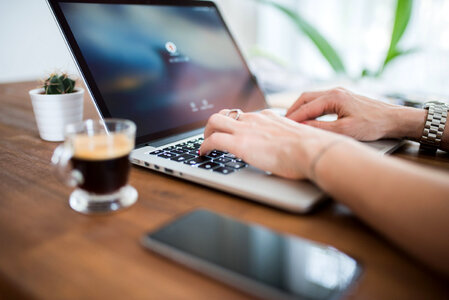 Woman Typing on Computer Desk photo