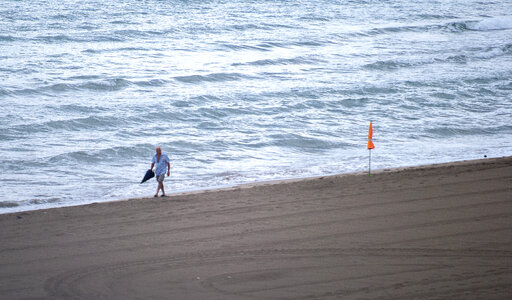 Man walking on the beach photo
