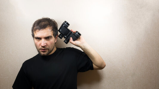 young man with binoculars photo