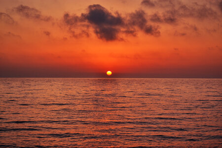 Sunset Scenery of the Sea with Red and Orange Colors photo
