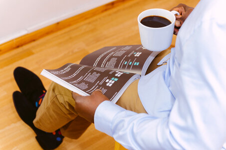 Businessman Reading Magazine and Drinking Coffee photo