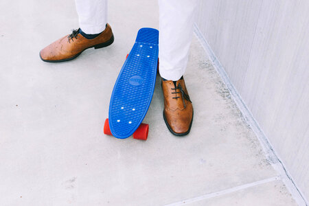 Man Standing Near Blue Skateboard photo