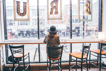 Woman Sitting at Window Coffee Shop photo