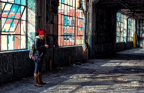 A Woman Taking a Photo in an Old Destroyed Factory photo