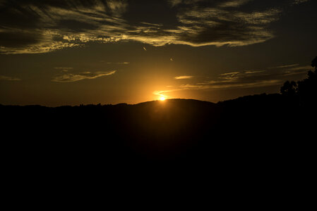 Sunset beyond hills at Great River Bluffs State Park photo