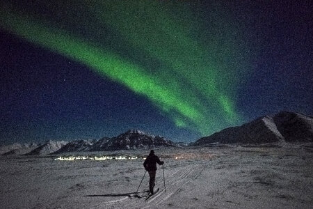 Man skiing under the aurora borealis photo