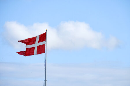 Denmark Flag With Cloudy Sky in Background photo