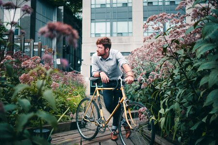 Men's Fashion Man With Bicycle Surrounded By Flowers photo