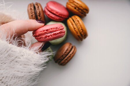 Woman Holding Colorful Delicious Macaroons photo