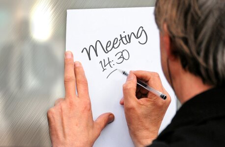 A man writing meeting photo