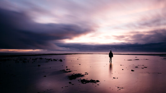 Stunning Long Exposure Sunset Shot Man on the Beach photo