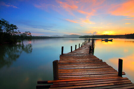 Wooden walkway into the lake sunset photo