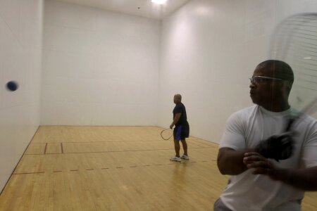 Male players playing a match of squash photo
