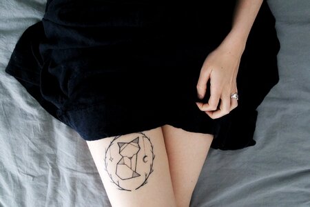 Top View of Woman with Artistic Paint Fox Tattoo on Her Leg Closeup on Body Art photo
