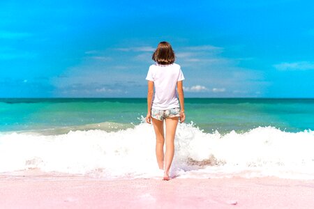 Girl Standing in Water on Seashore photo