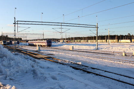 A train is arriving on a snow covered train station in the winter