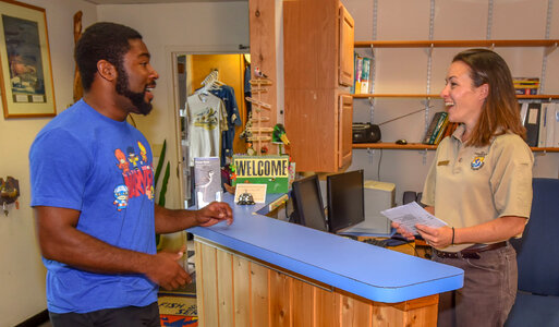 FWS Staffer greets visitor at visitor center desk-3 photo