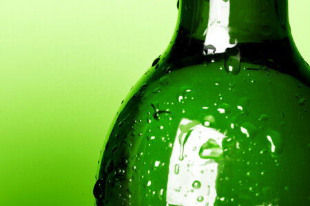 Bottle with water drops - Green Background photo