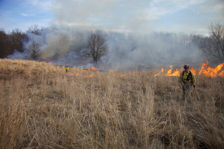 Firefighter walking away from burn area
