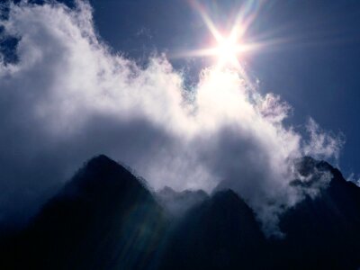 Sunny landscape in mountains and the dark blue sky photo