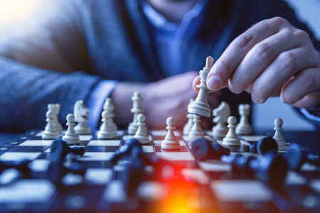 Chess financial business strategy concept. Team leader holding chess piece. photo