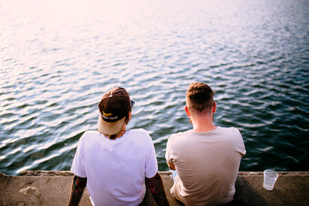 Two Guys Sitting at the Wharf, Drinking, Talking and Wondering photo