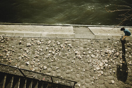 Boy Playing with Stones on the Embankment photo