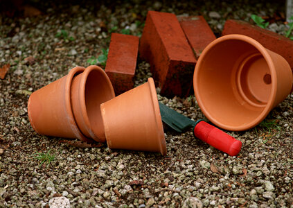 different sizes of terracotta pots with gardening tool photo
