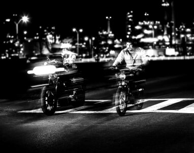 Motion of Two Bikers Racing on the Street at Night photo
