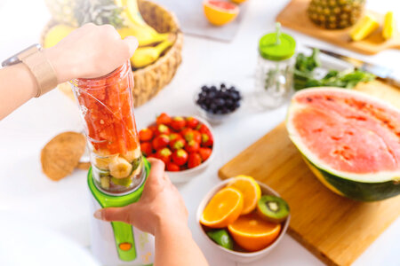 1 Hands of woman preparing smoothie fruit drink photo