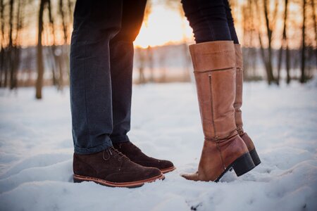 Man Woman Kiss Snow Boots Sunset photo