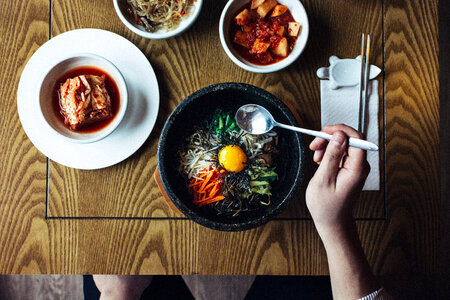 Eating Korean bibimbap and kimchi photo