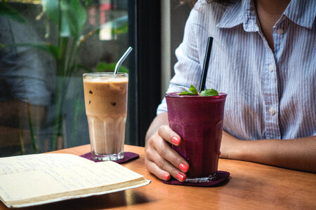 Girl having a healthy purple smoothie photo