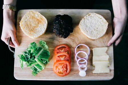 Delicious Fresh Homemade Burger Ingredients on a Wooden Tray photo