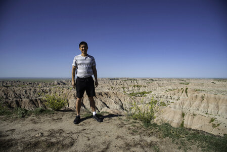 Standing on the edge of a cliff at Badlands National Park photo