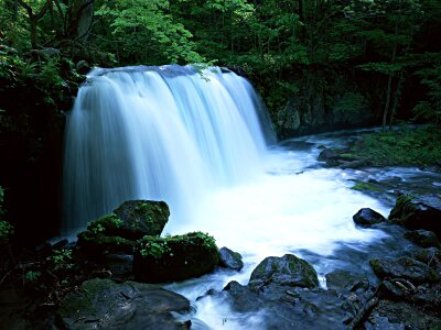 Water fall in spring season located in deep rain forest jungle photo