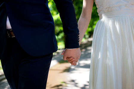 Bride and Groom Holding Hands photo