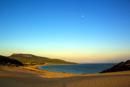 Beach landscape with moon in blue sky