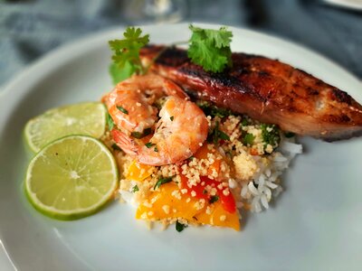 Vegetable couscous with shrimps and fish photo