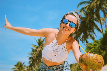 Happy Young Girl Drinking Fresh Coconut Water photo