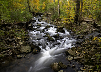 Fast moving rapids in the autumn forest at Baxter's Hollow photo