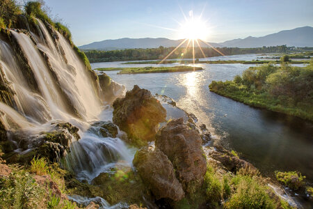 Sunlight and majestic waterfalls on the snake river in Idaho photo