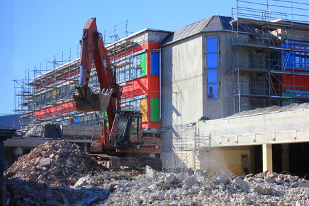 Digger knocks down a house photo