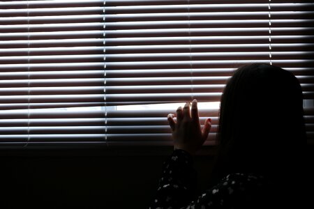 Girl Peaking Outside Window photo